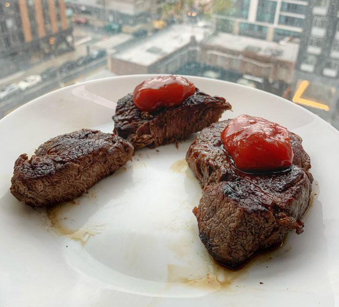 Steak well-done with ketchup.
